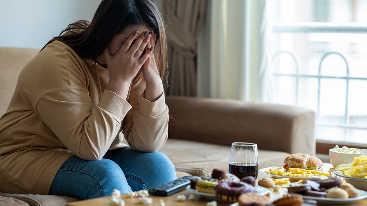 stressed woman with food on table